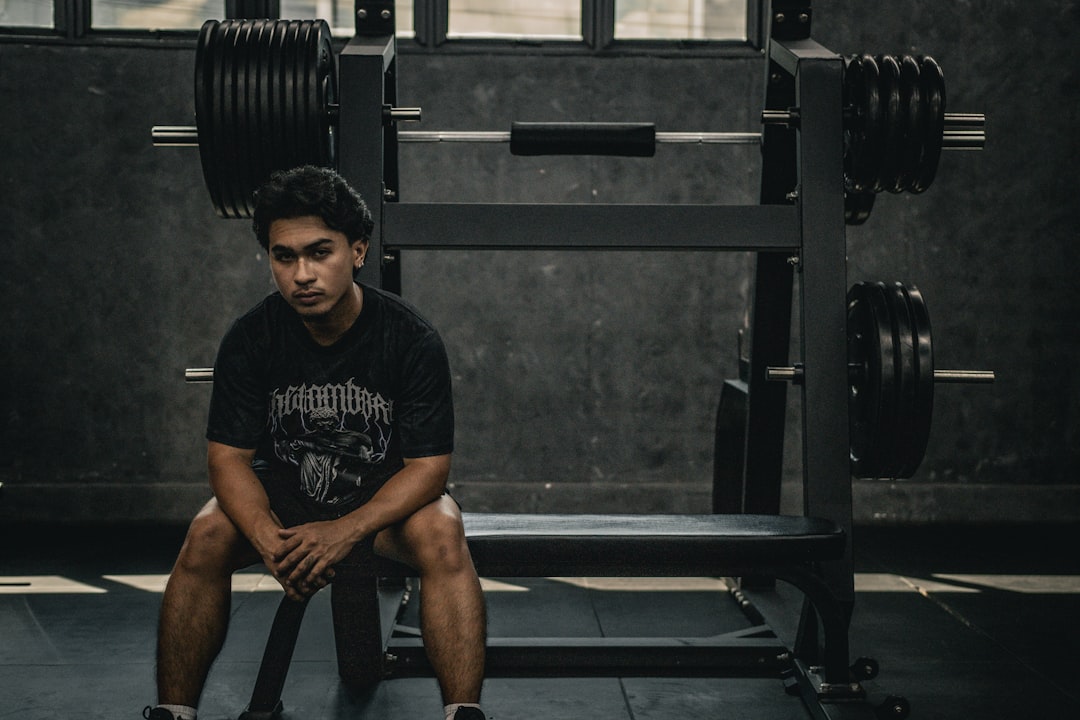 An athlete sitting alone in a quiet, reflective moment